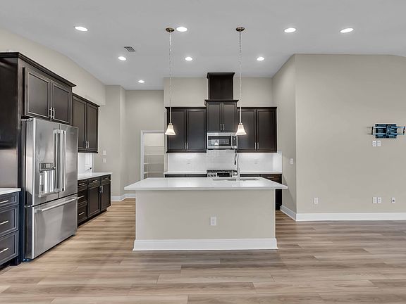 Kitchen with selected flooring that flows throughout the home's main living space.
