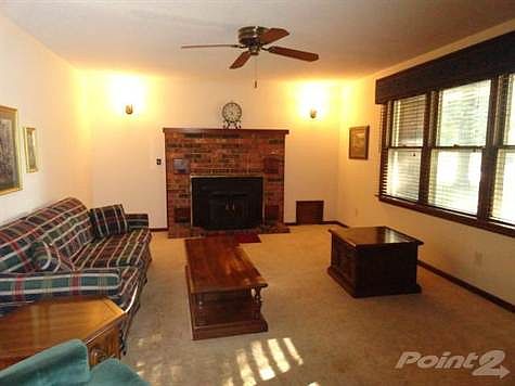 Formal living room with triple windows facing the West.