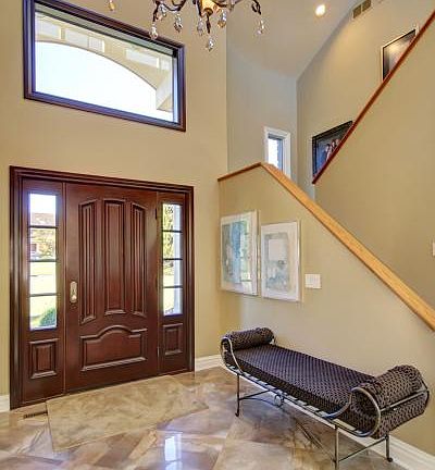 Stately 2-story entrance boasts an impressive floor and stunning chandelier.