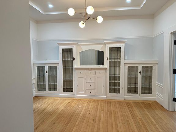 The dining room, featuring built-in cabinetry, loads of light and a vaulted ceiling.