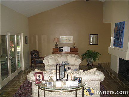 The formal living room with cathedral ceiling and fireplace