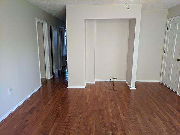 Living room view to kitchen entry and 3 bedrooms.