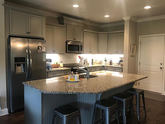 Kitchen with stainless appliances and granite countertops.