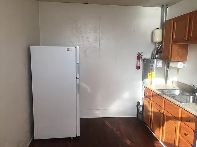 Kitchen area, with gas hotwater heater, electric stove and refrigerator, room for table and chairs. The whole apartment has been completely cleaned and painted from top to bottom.