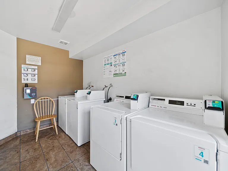 Convenient on-site laundry facilities featuring multiple washers and dryers.