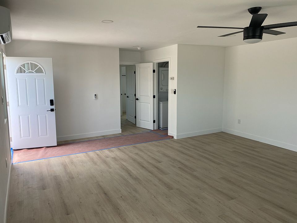 living room looking south east. Entrance to laundry room and bedroom.