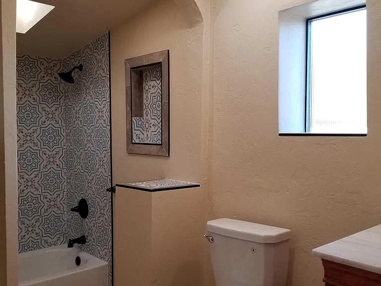 Custom tile shower, accents, fluted glass for privacy and all new fixtures.