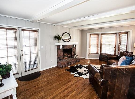 Family room has a gas fireplace and french doors leading to the deck.