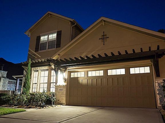 The architectural design and details shine through from the tandem garage doors w/windows to the wooden trellis' above!