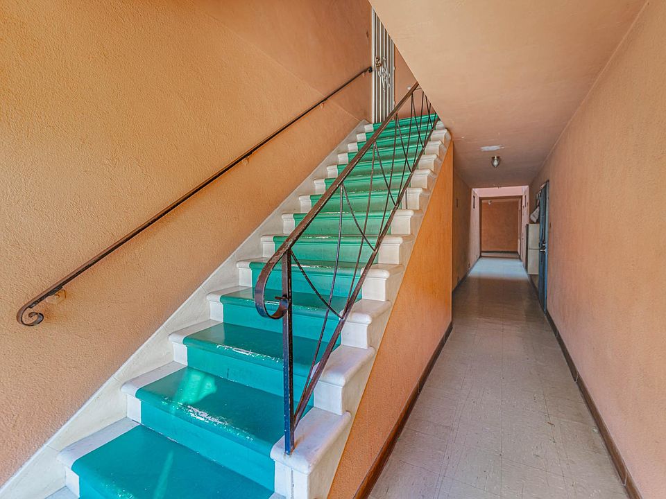 Walk by the stairs and home is to the left.