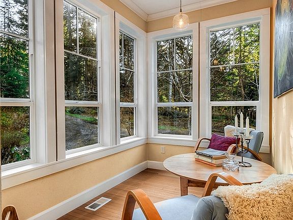 South facing sun room, painted a soothing yellow to bring in the feeling of summer all year. Wonderful spot to enjoy a beverage late in the day. 