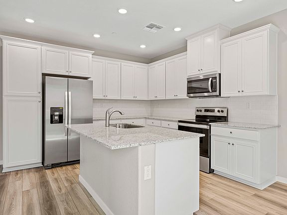 The kitchen has stainless steel appliances and granite countertops.