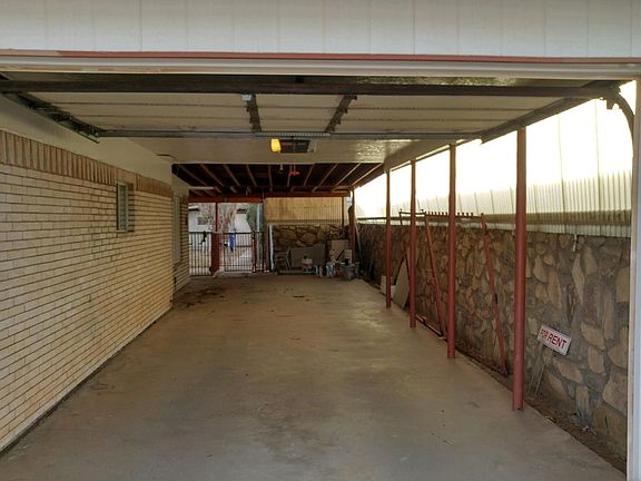 Open carport holds two vehicles; Includes two garage door remote controls. Access to backyard is possible through swing-able gate.