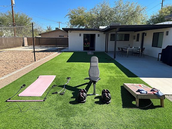 Large fenced backyard, turf grass, with sand volleyball court, horseshoe pit and plenty of room for gatherings.