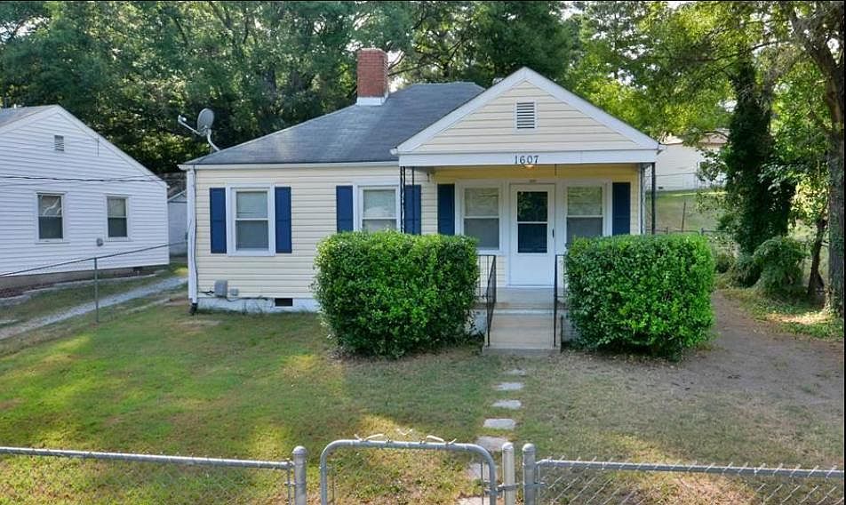 Front view of home, fenced in yard and set back from the street