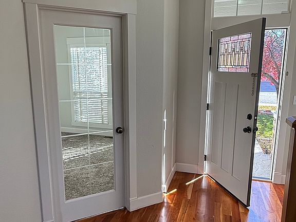 View of front door and office/6th bedroom glass door.