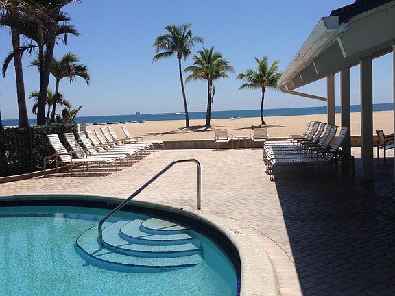 Community pool overlooks beach