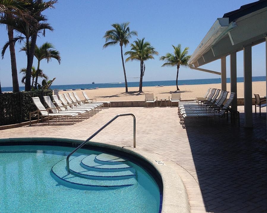 Community pool overlooks beach