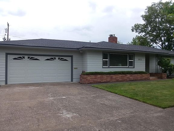 Front of home by driveway.