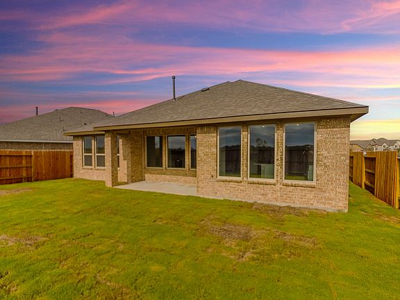 Fenced in backyard with covered patio