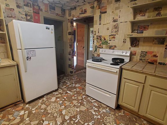 Kitchen leading to bonus room, 2nd. bedroom, 2nd bath.