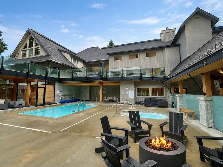 Modern poolside retreat with fire pit_03202026