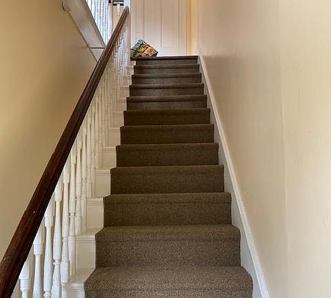 Newly painted and carpet runners on stairs to aparmtment