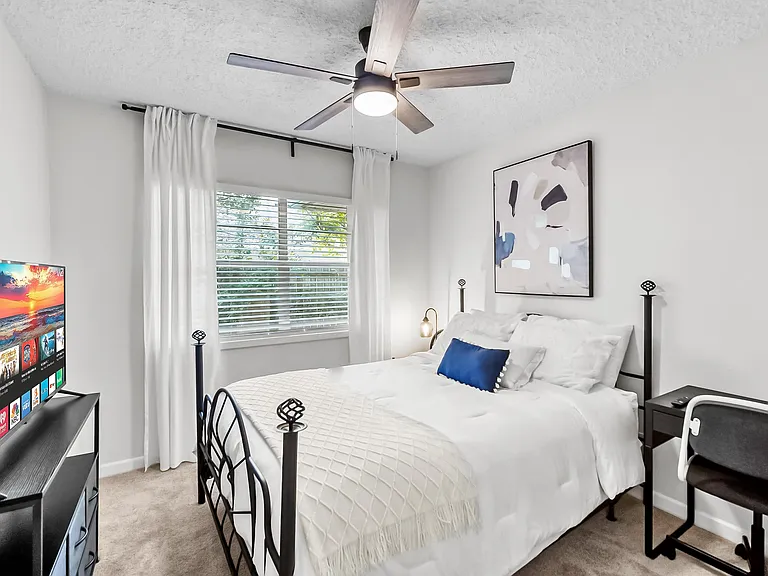Queen bed with TV, work station, closet and dresser