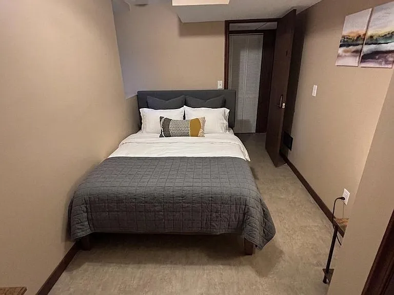 Private bedroom with a full bed, neutral finishes, and easy-access closet spaceideal for rest and daily storage needs.