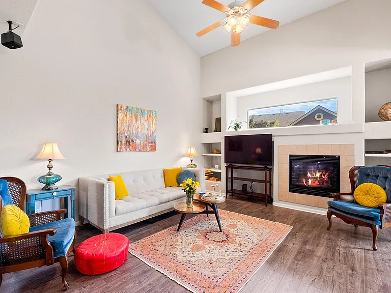 Living room with shelves and a fireplace