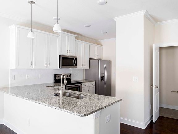 Kitchen features granite counters and breakfast bar!