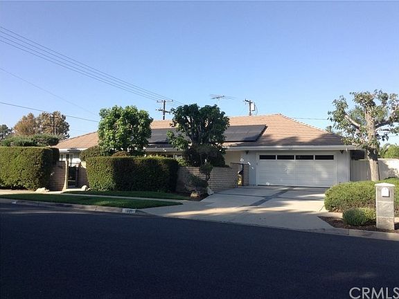 Front of home with abundant foliage for privacy and 2 gated entrances