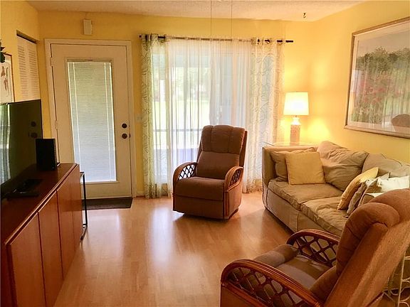 Attractive, light colored, low maintenance laminate flooring in living/dining room/kitchen
