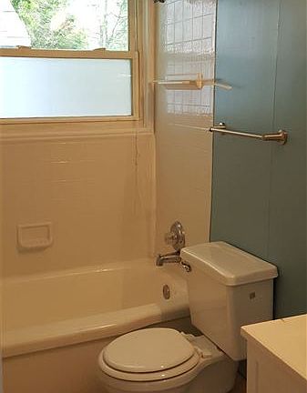 Bathroom with plenty of storage behind the door.