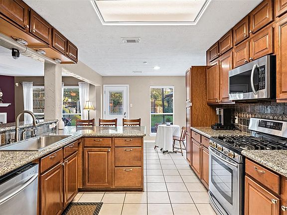 This kitchen is the heart of the home! It boasts lots of natural light, a nice sized pantry, stainless steel appliances, granite, ceiling height cabinets and eat-in bar!