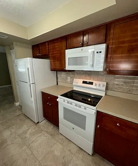 New GE full appliance package. The range oven has a glass top. The dishwasher has top controls. The fridge has glass shelves.