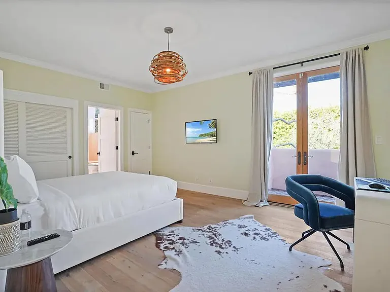 Guest bedroom equipped with modern amenities, including a TV.