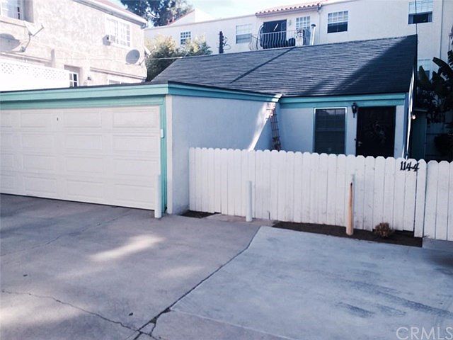 Fenced, gated front yard connects to rear and side yards