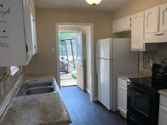 Kitchen view towards laundry room and entrance