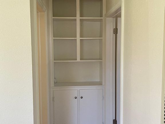 Cupboard at the end of the hallway.