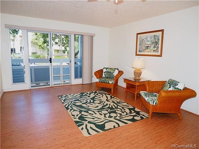 Spacious living area with wood laminate flooring.