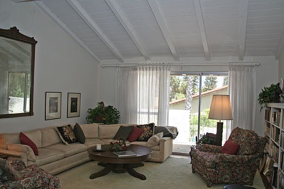 living room with hardwood flooring under rug