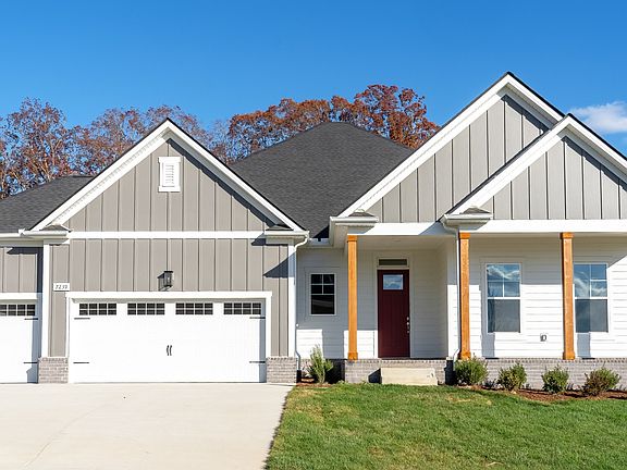 Exterior of single-story home with 3-car garage and covered front porch