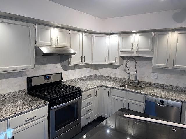 granite counter tops and white marble back splash
