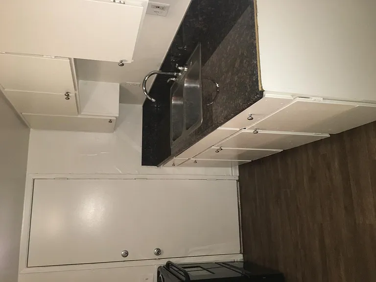 Another view of the kitchen. Door leads to parking lot space