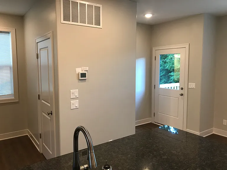 Rear entrance to private back deck along with powder bath and pantry