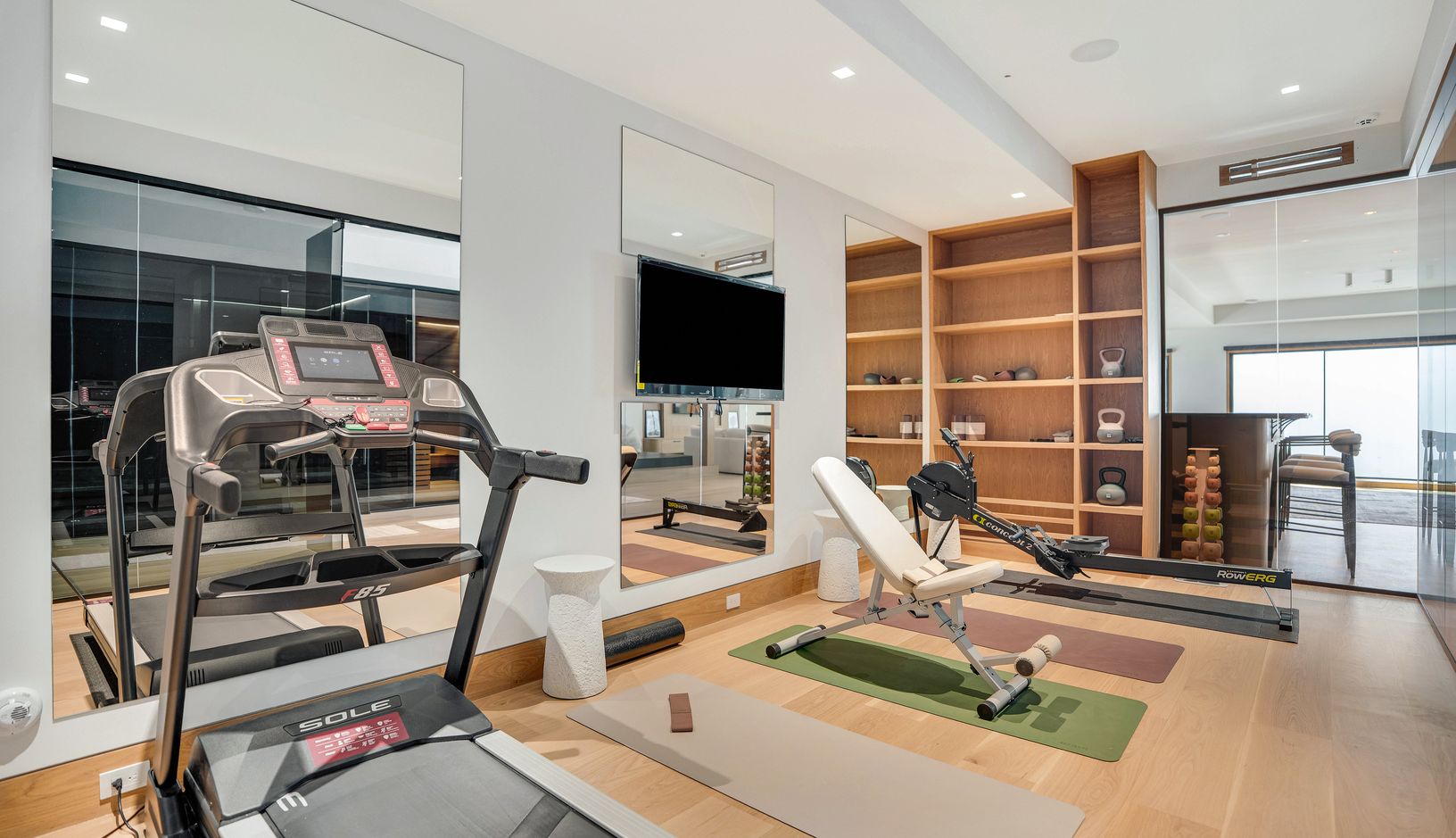  Pro treadmill, pro rowing machine, weight bench, dumbbells, kettle bells, yoga mats, TV in mirror