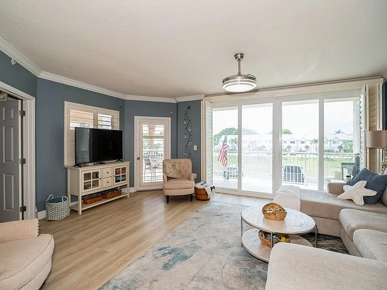 Living Room with double chaise sofa, smart TV, 8' sliding doors, shutters, LVP, seating for 6