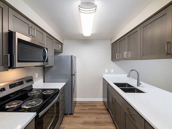 New renovation features quartz counters, custom cabinets, AC, and stainless steel appliances.