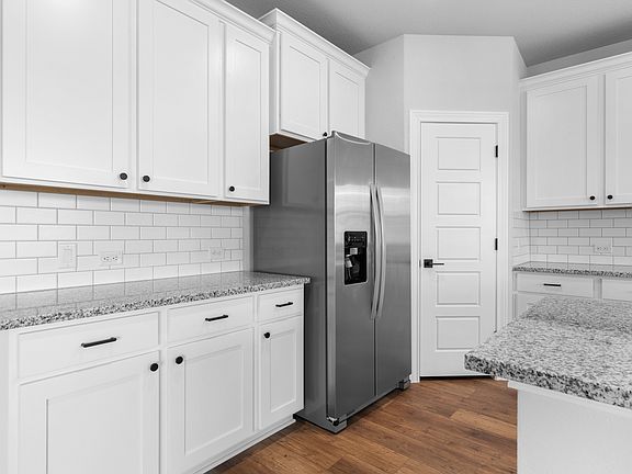 The kitchen has sprawling granite countertops.